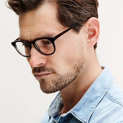 Mid adult man in spectacles, looking away