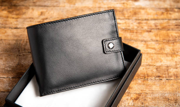Black leather wallet on a wooden table top view
