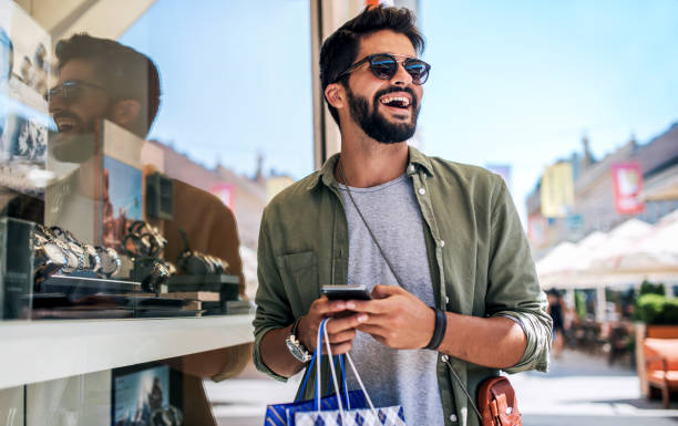 Modern young man enjoying in shopping. consumerism, fashion, lifestyle concept
